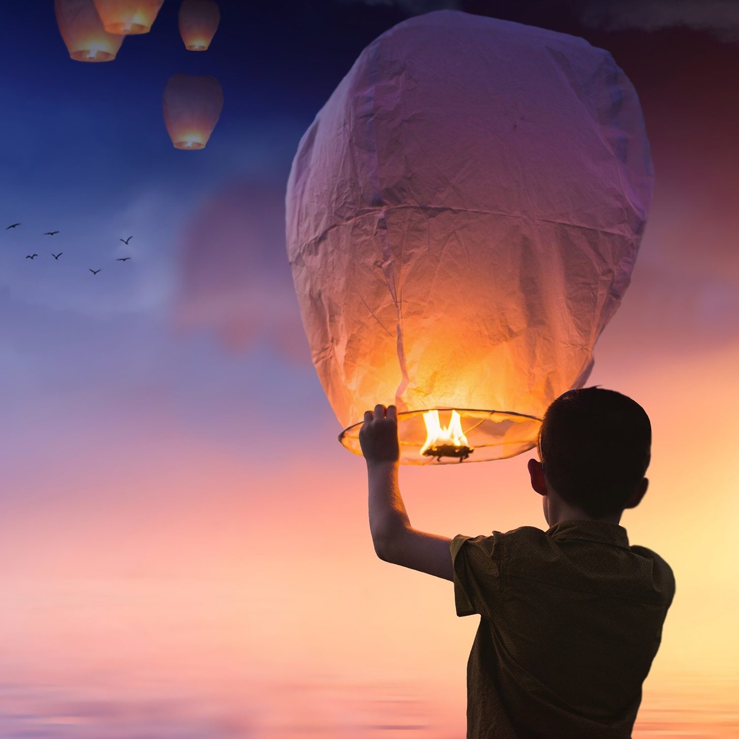 Meine Berufung und Gabe: Ein Kind lässt einen Papierballon steigen vor einem bunten Horizont